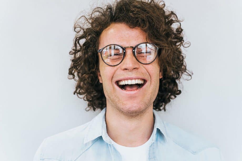 Man with glasses smiling image 920x613